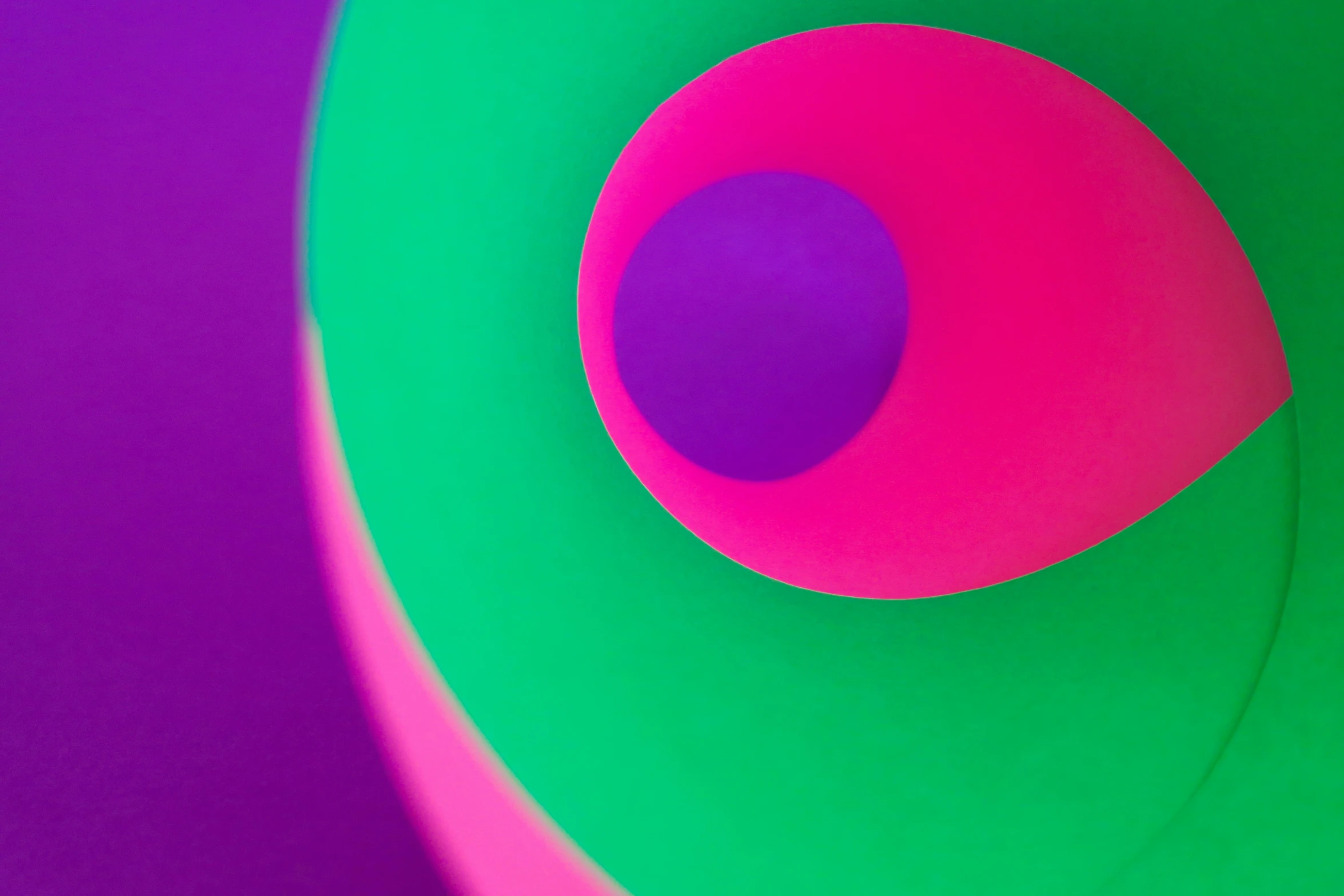 a colorful circular object is shown in purple, green and pink