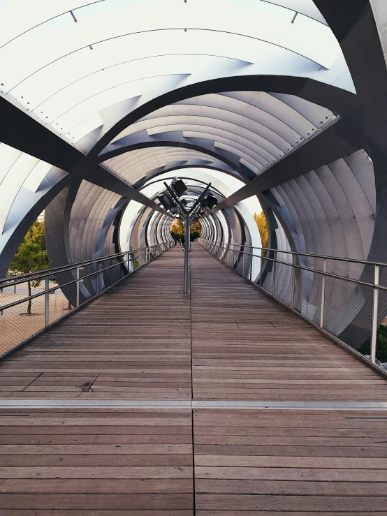 a wooden walkway next to a building under a blue sky