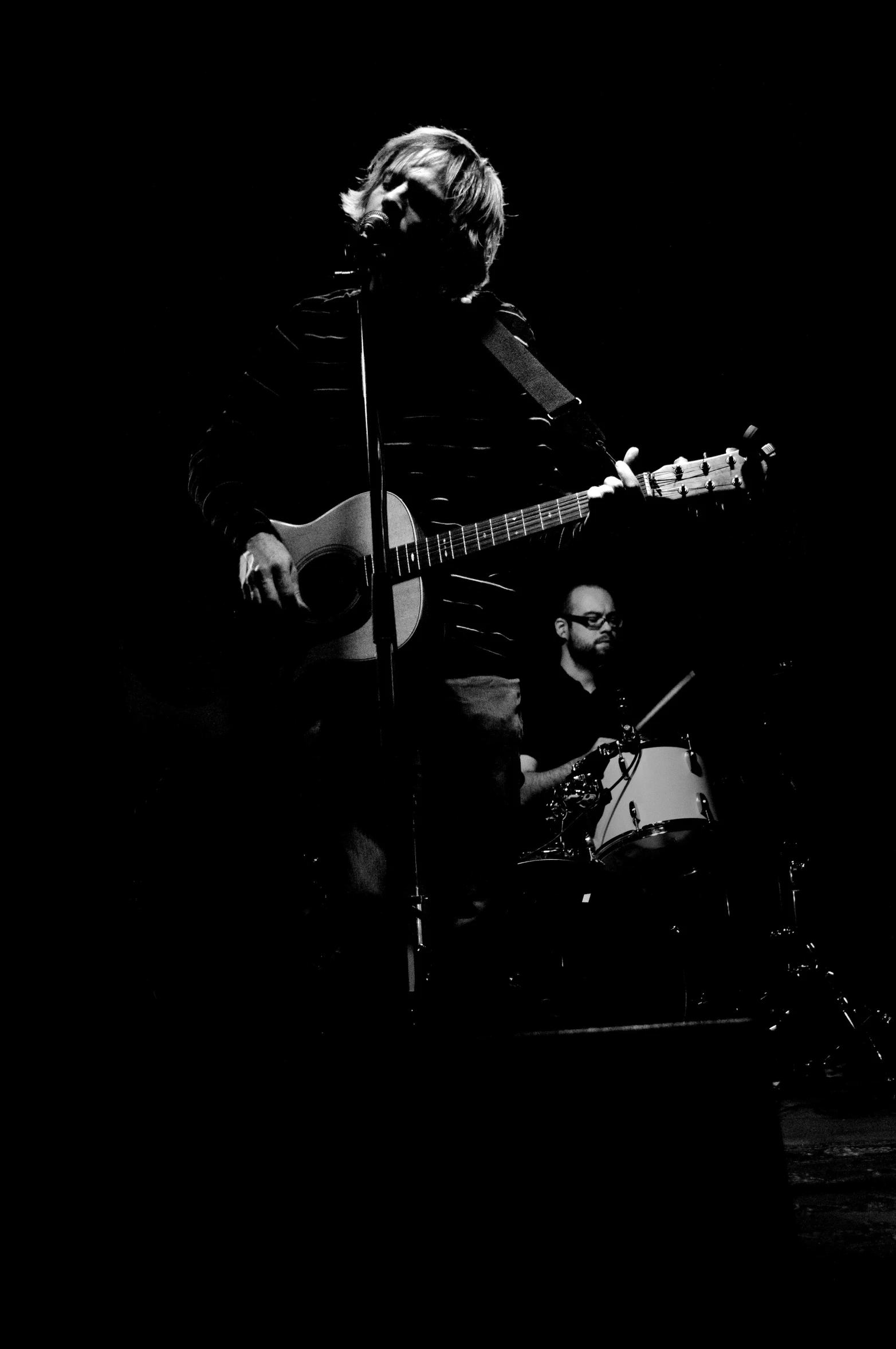 a black and white po of two men playing guitar