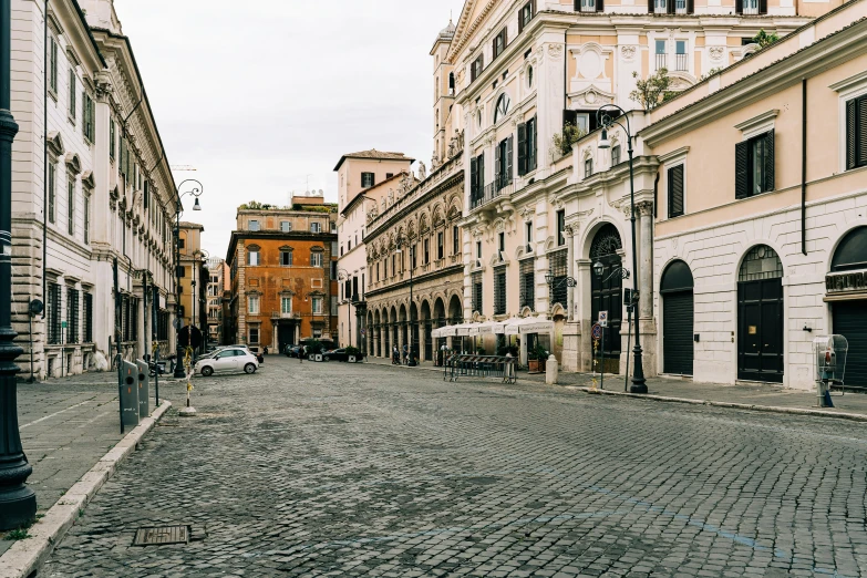 a cobblestone street with a lamp post and buildings