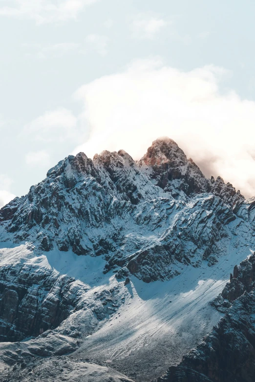 a lone plane flying above a mountain range