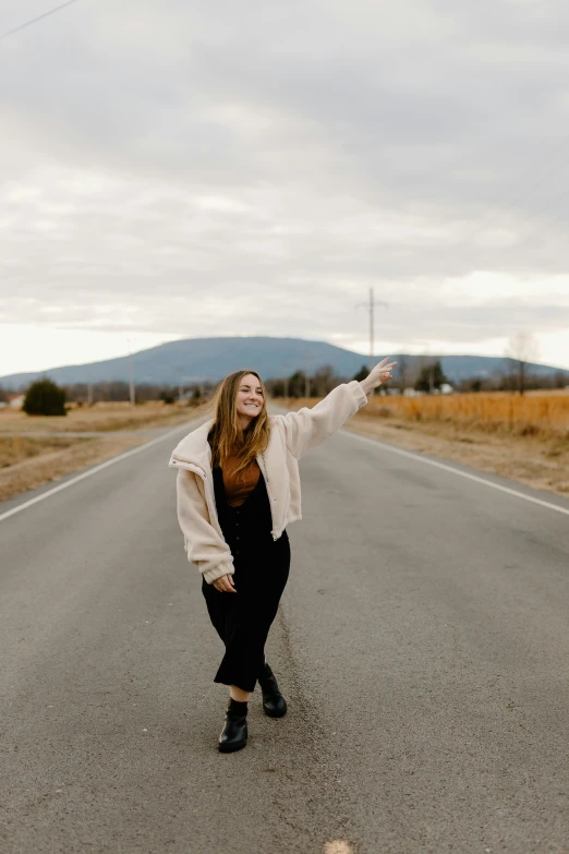 a woman standing on the side of the road