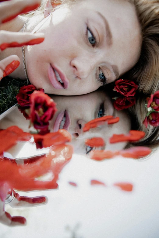 a girl laying on top of a white surface