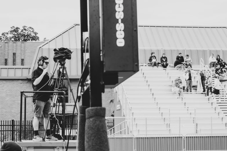 people at an outdoor event looking out towards the street