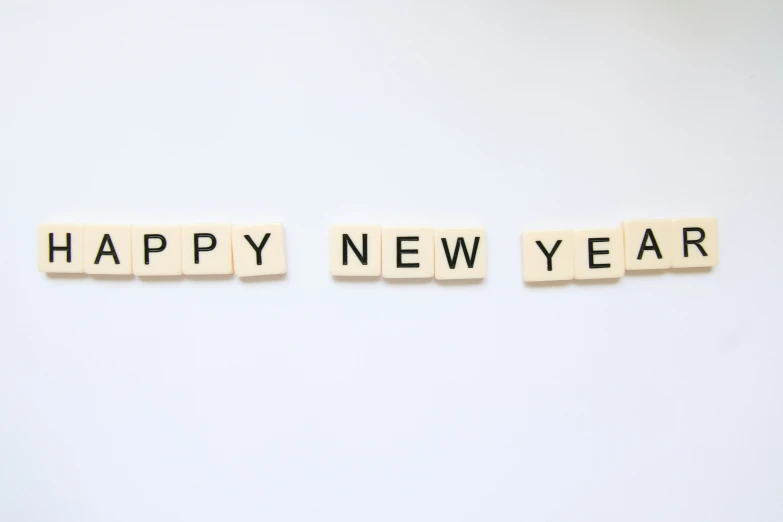 the words happy new year written on wooden letters