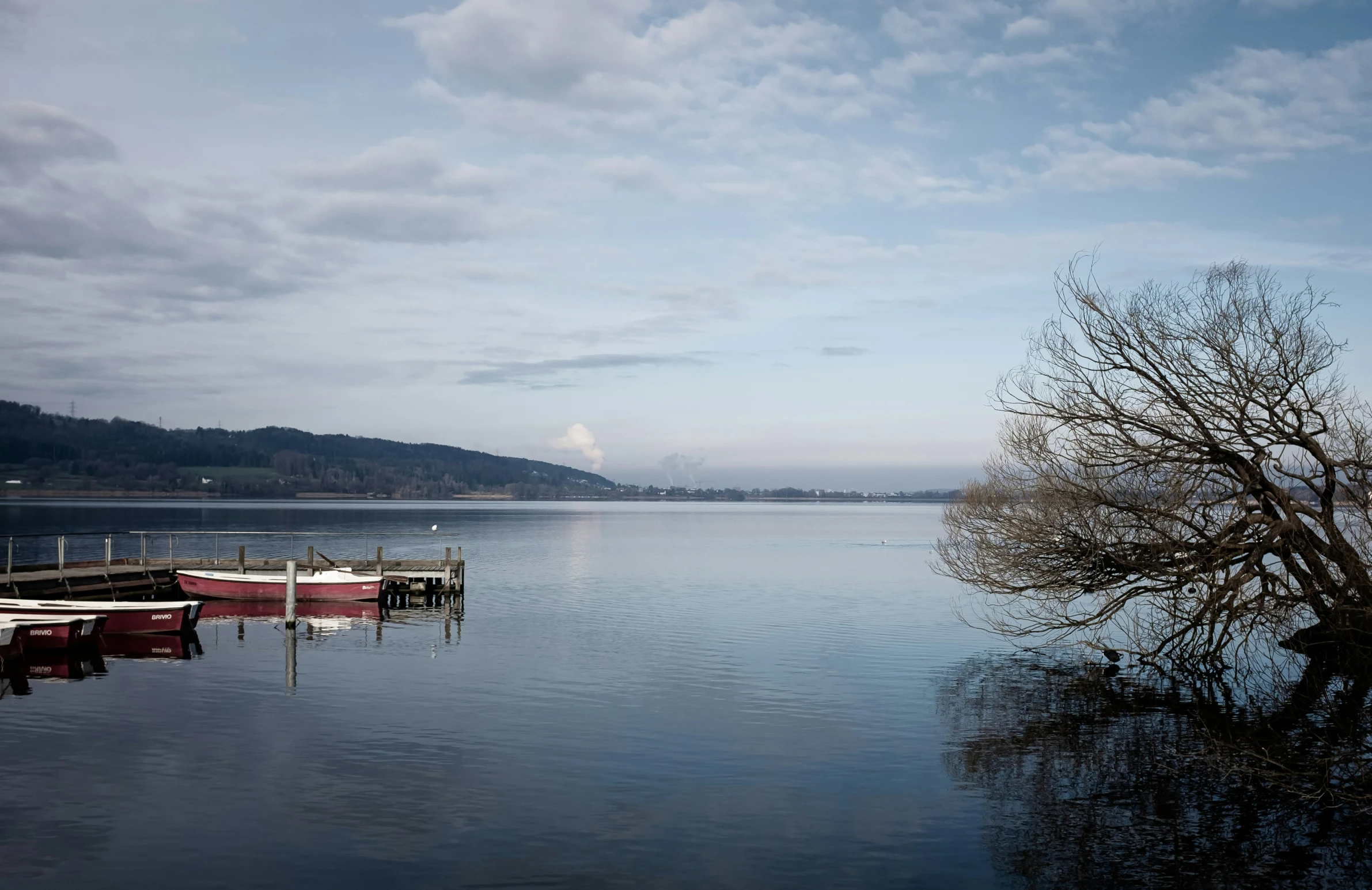 a boat tied up at the end of a dock