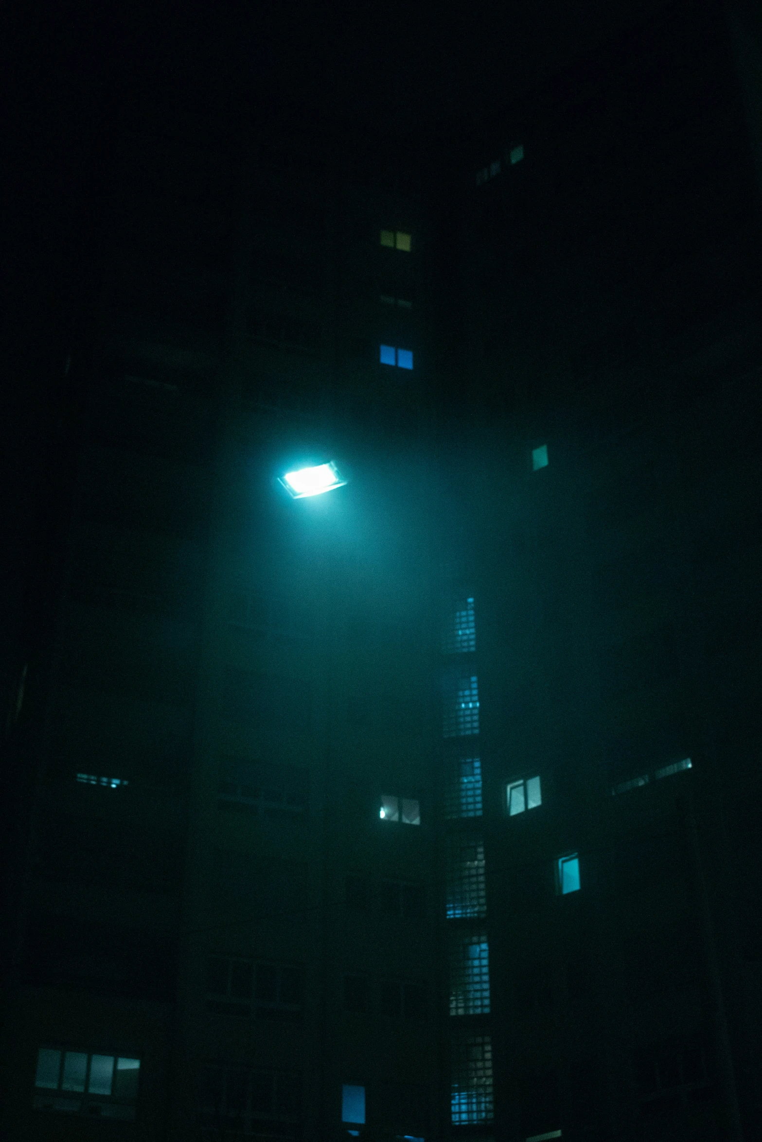 the silhouette of an object at night on a building