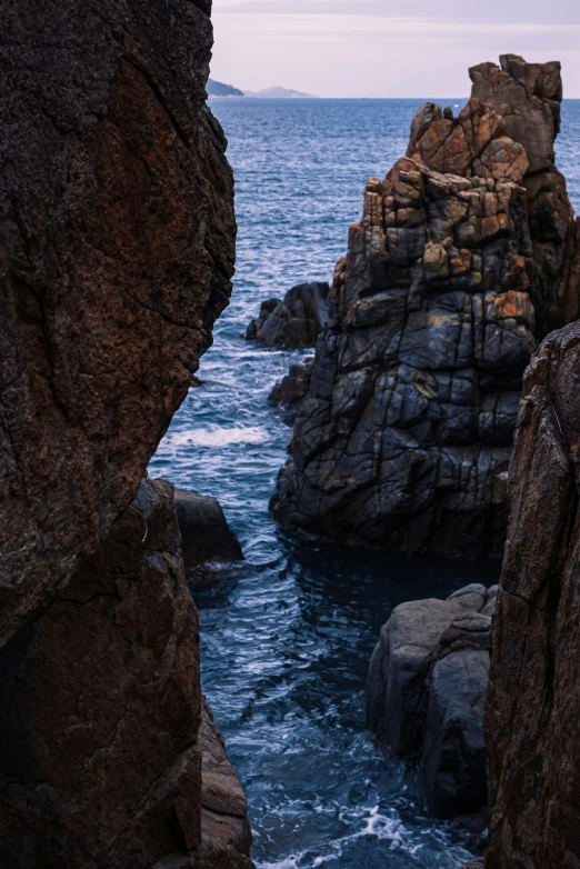 a cliff that is next to a body of water