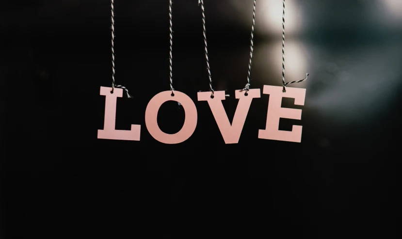 pink love on chains hangs from the glass
