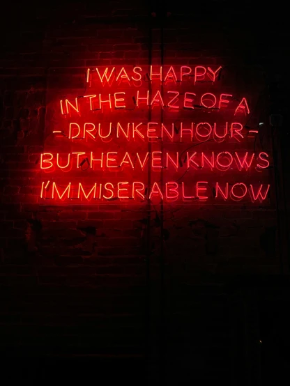 the words in neon lights are written in bold red and black letters