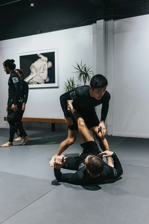 a group of people engaged in martial on an indoor floor