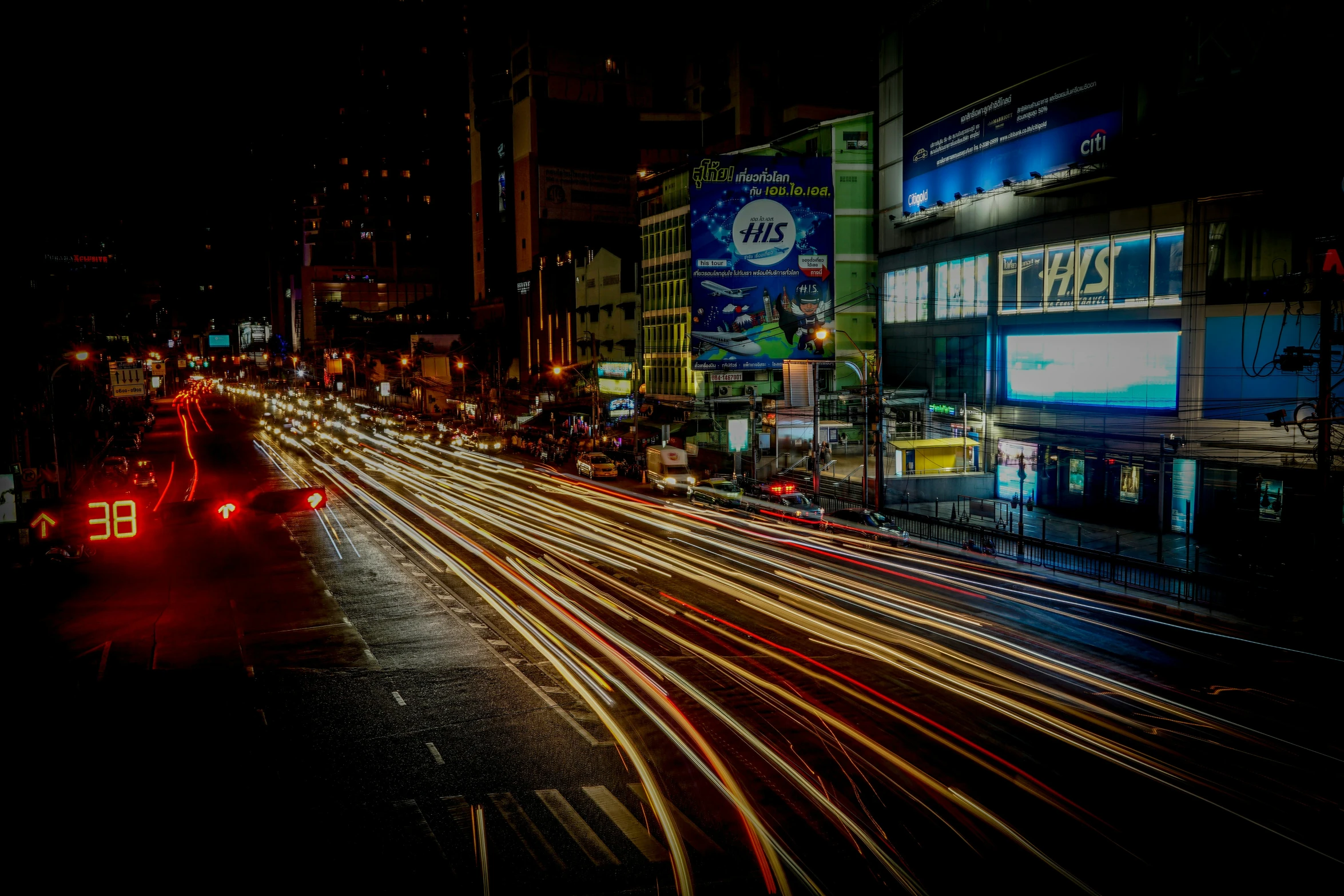 a city at night filled with traffic and moving lights