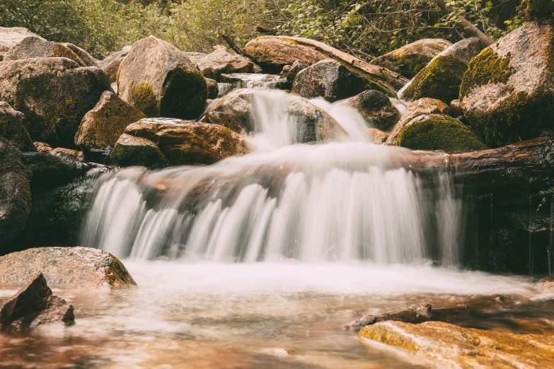 the small waterfall is flowing very high into the river