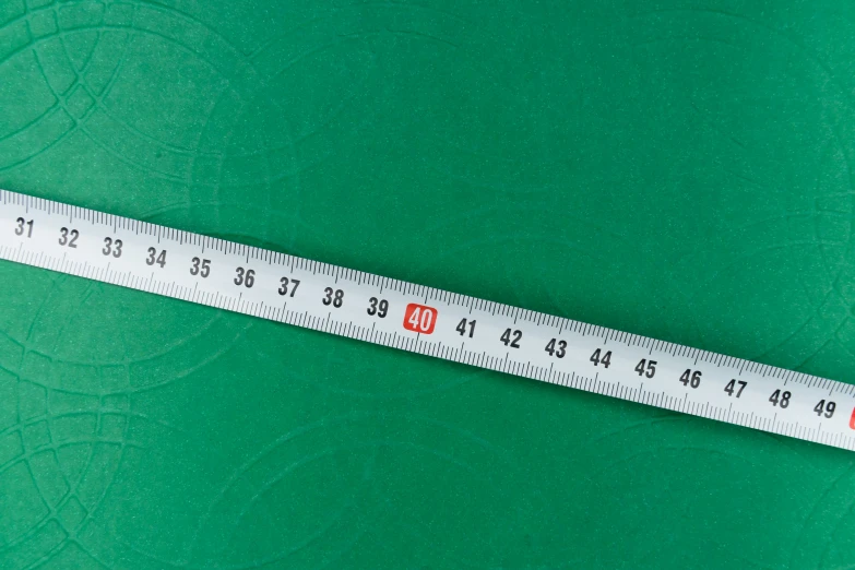 a tape measure sitting on top of a green surface