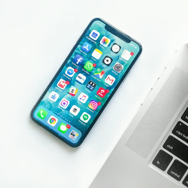 an iphone resting on a laptop keyboard