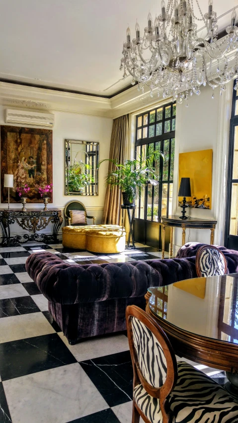 a living room with lots of furniture and a big chandelier