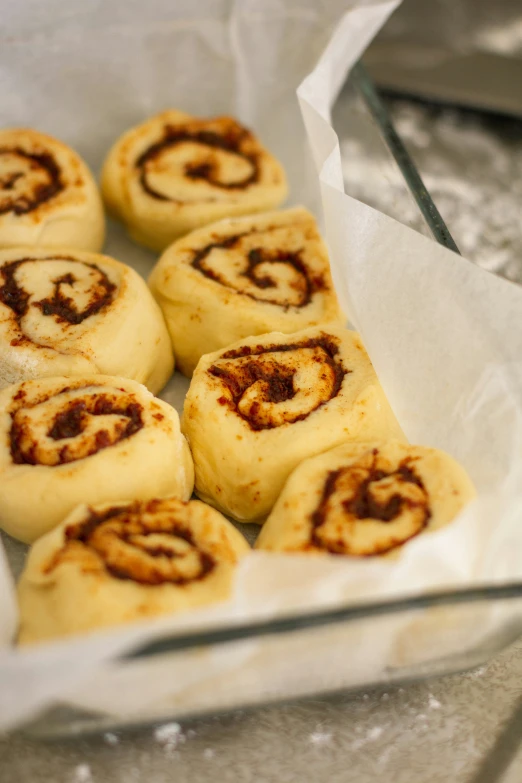 a plate filled with baked cinnamon rolls covered in sugar