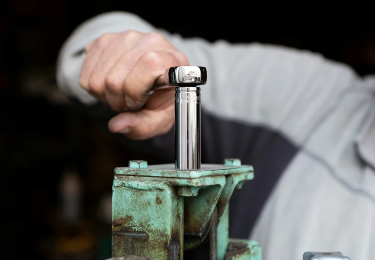 a man is holding onto the handle of a piece of machinery