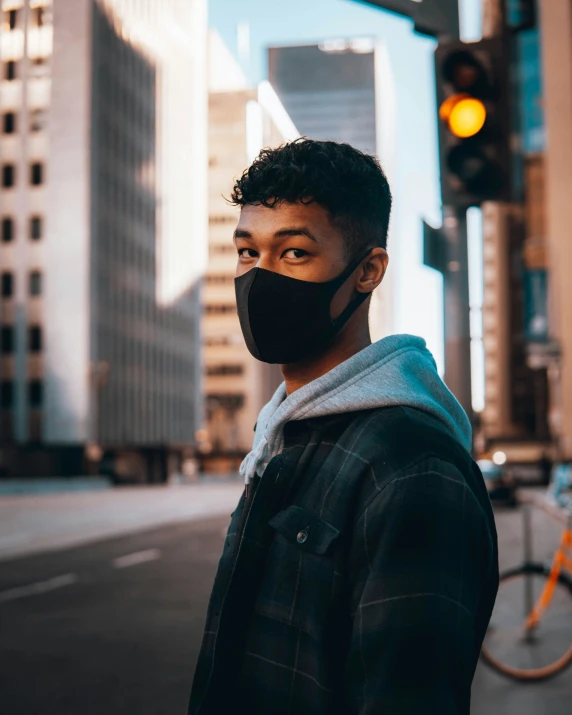 a man wearing a black mask is looking at the camera