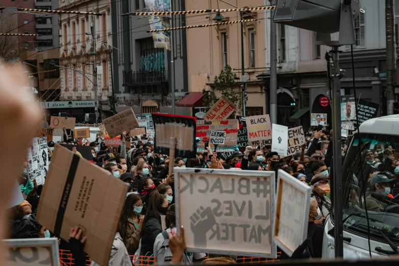 there are people holding up signs in a street