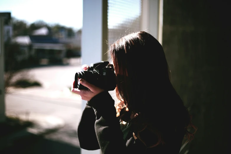 the woman is taking the picture with her camera