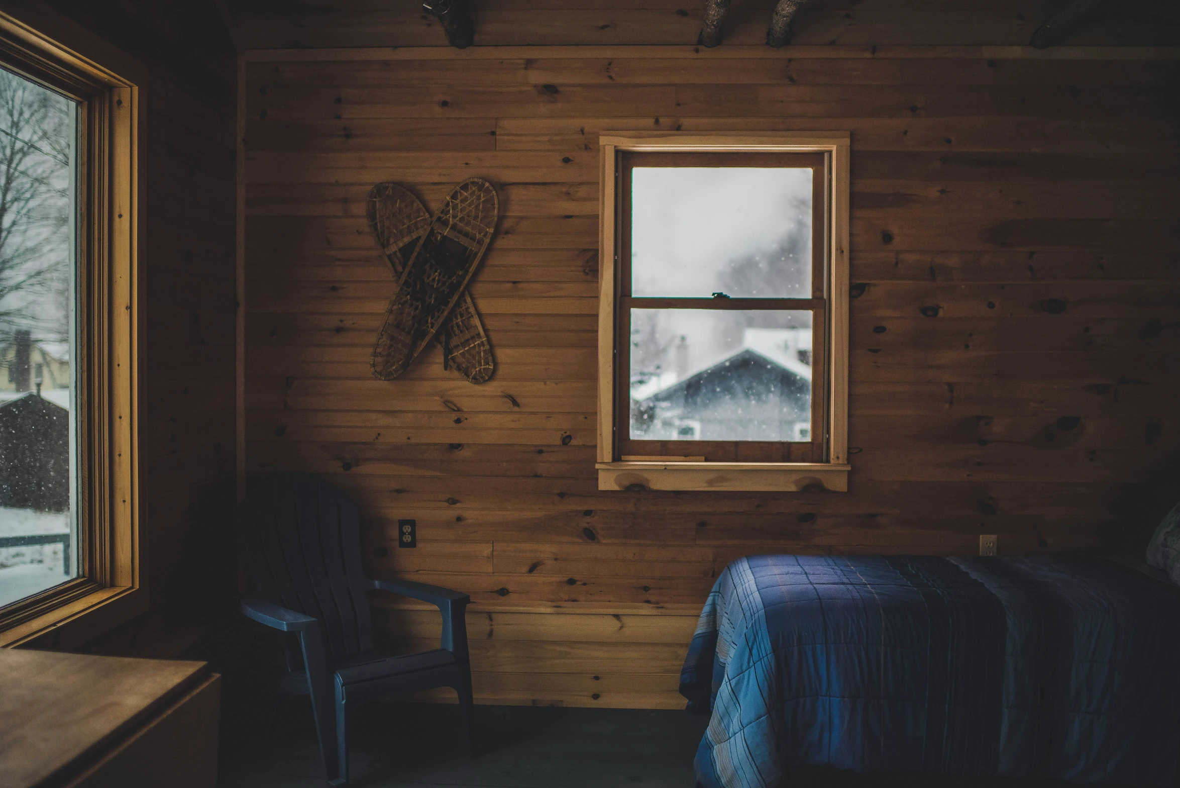 a bedroom that is decorated with wood and has a bed