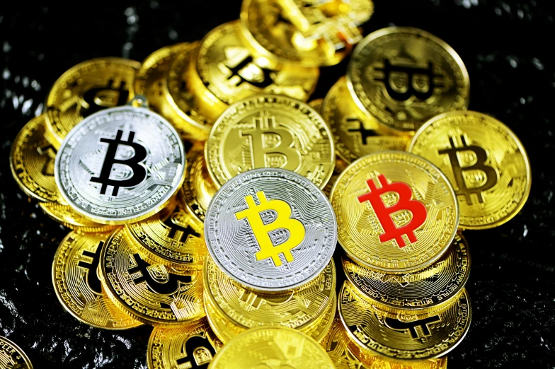 gold bitcoins, lit by red light