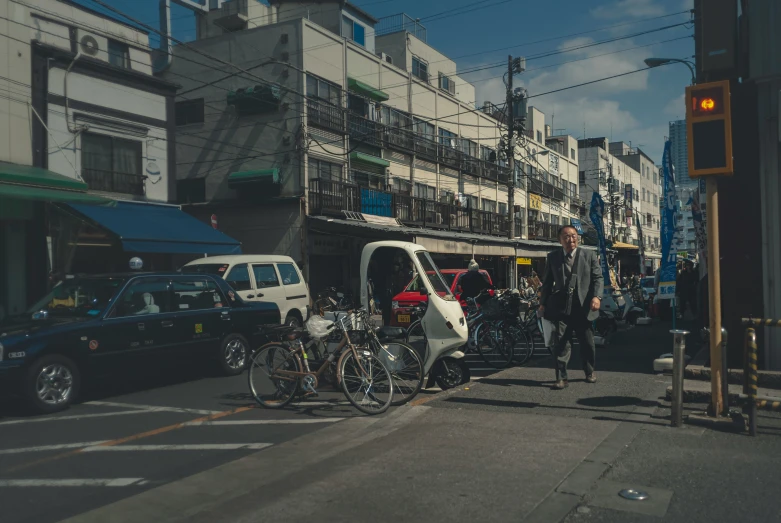 people at a busy street intersection with their bicycles