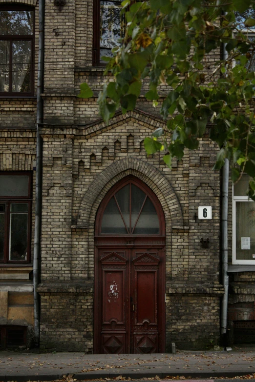 an old brick building with two doors and windows