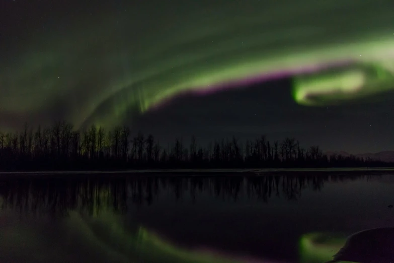 an auroral is seen in the sky above water