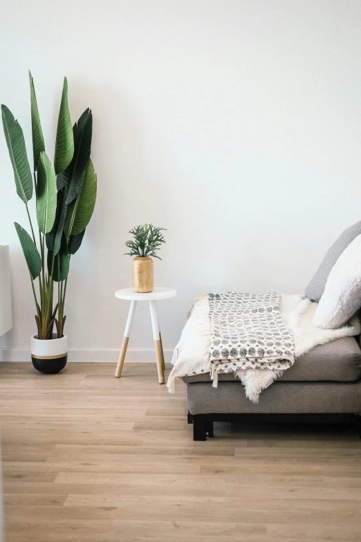 a room with a gray couch and white chair