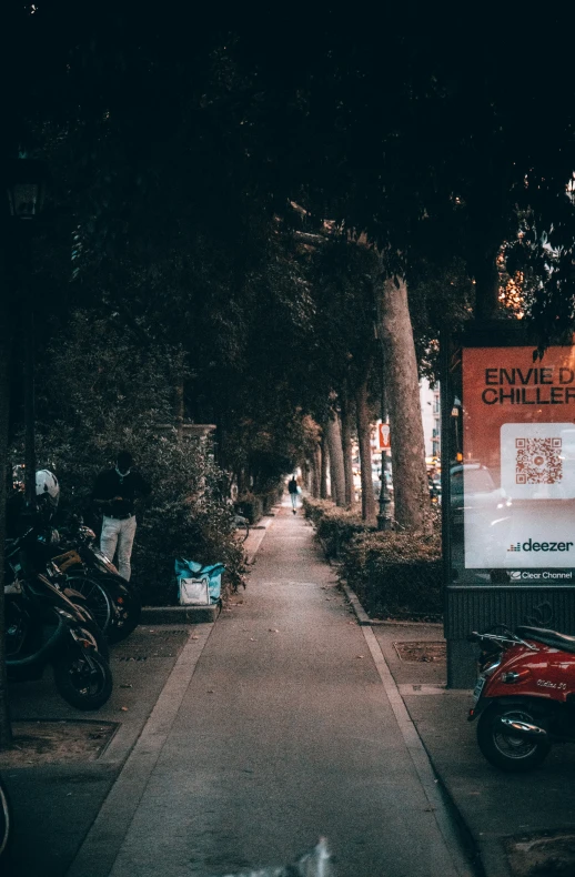 the sidewalk is dark with no one walking