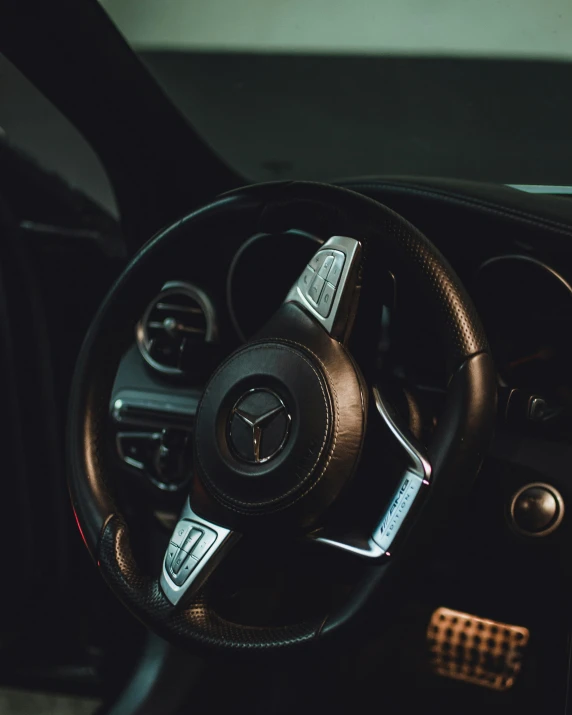 inside of the interior of a car with steering wheel and dashboard