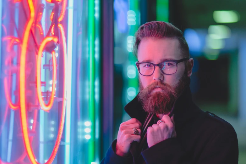 man standing in front of neon light