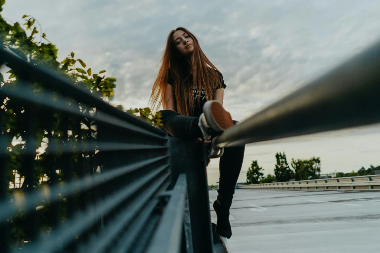 a woman is leaning on a railing outdoors