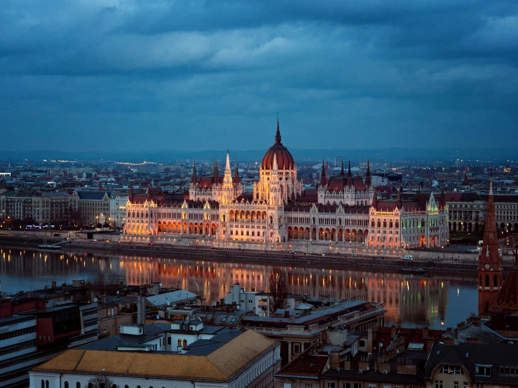 a cityscape with buildings reflecting in the water at dusk