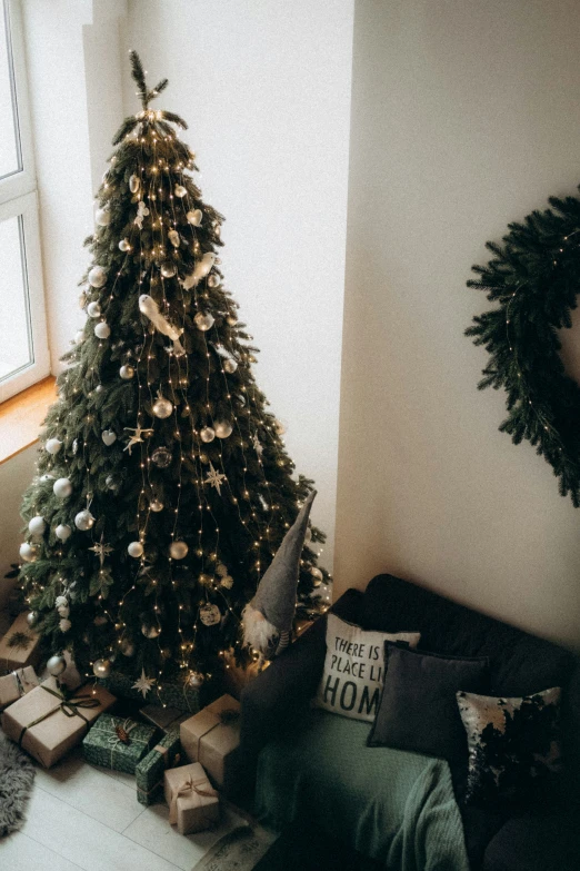 a bedroom has christmas tree decorations and presents in boxes