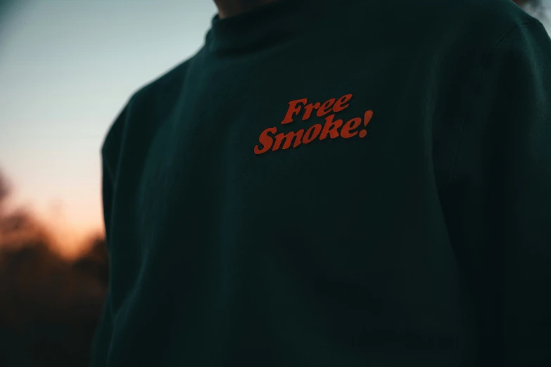 a man wearing a sweatshirt with the word free smoked written across it