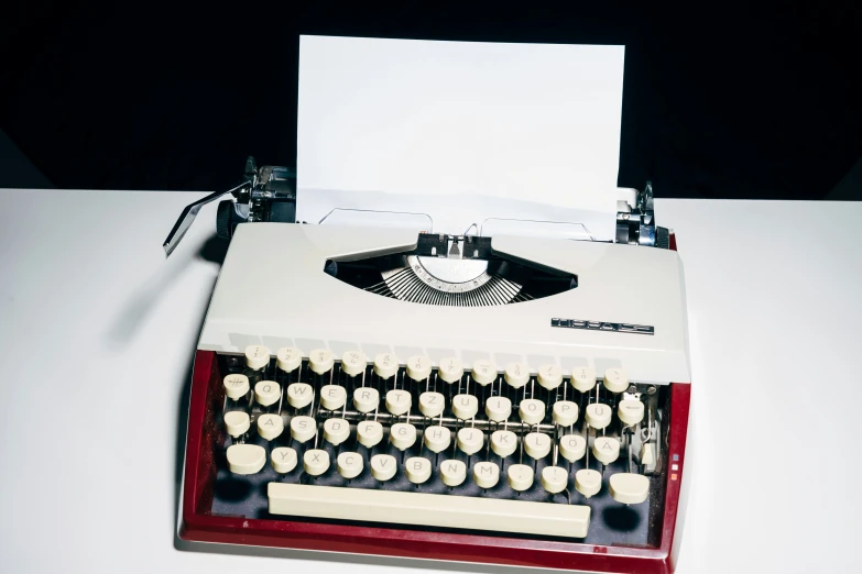 an old fashioned white and black typewriter