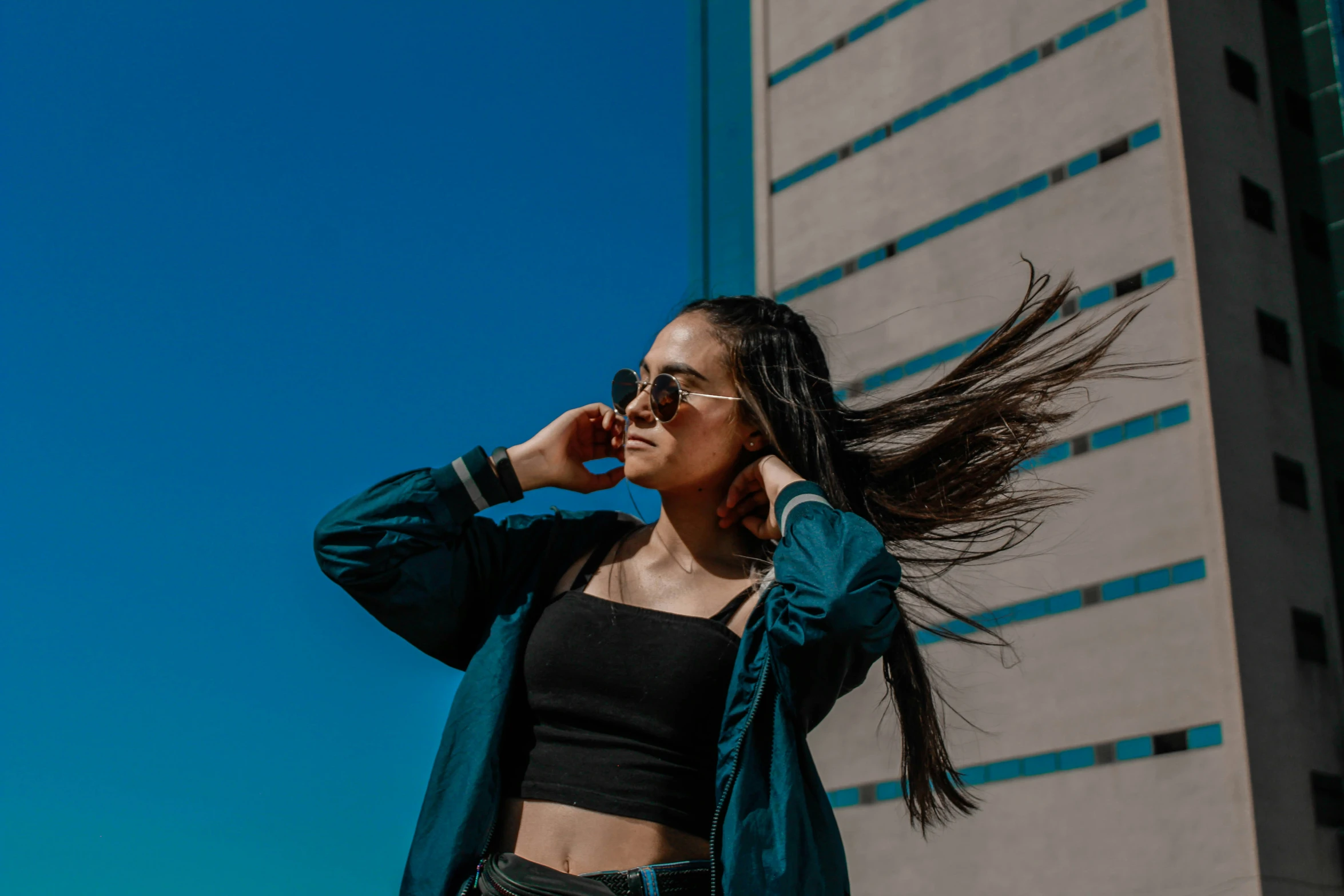 a young woman with dreadlocks is talking on a cellphone