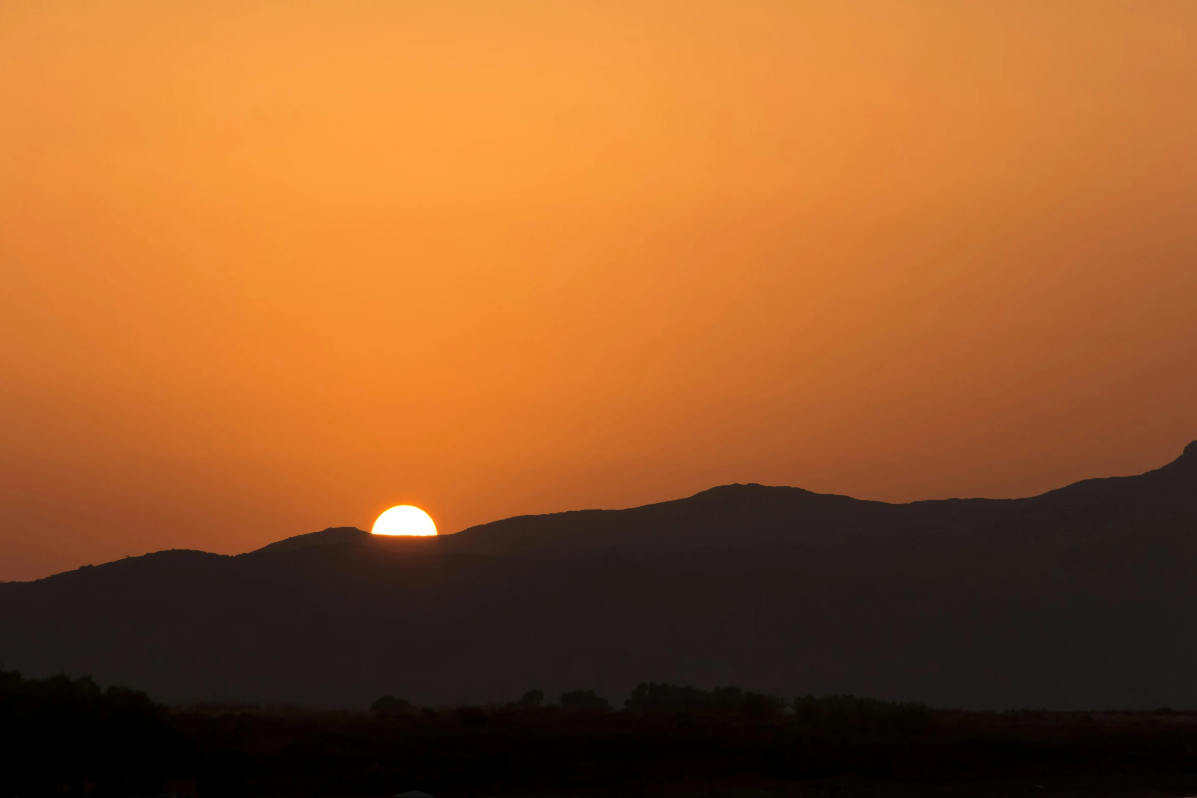 sunset with some mountains in the background