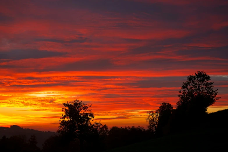 a bright red sky is shown during the day