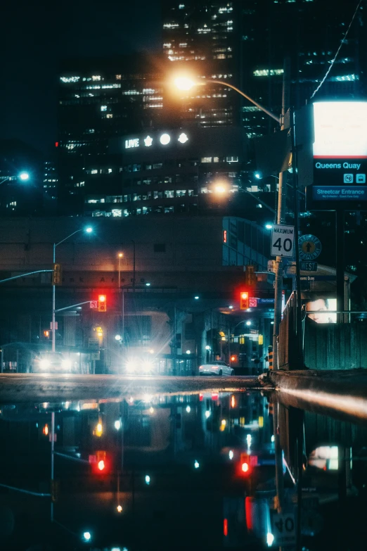 a night time picture of rain and traffic lights