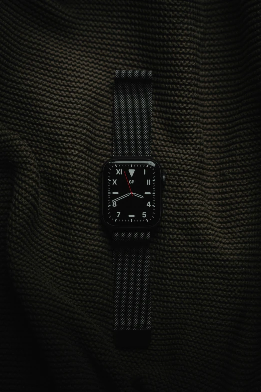 a black watch with a small white screen on it