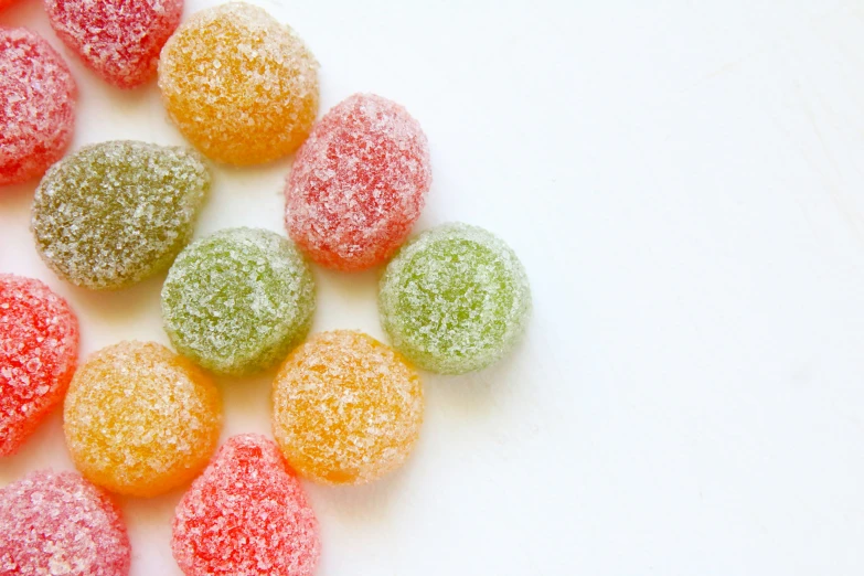 a close up of powdered donuts on a white surface