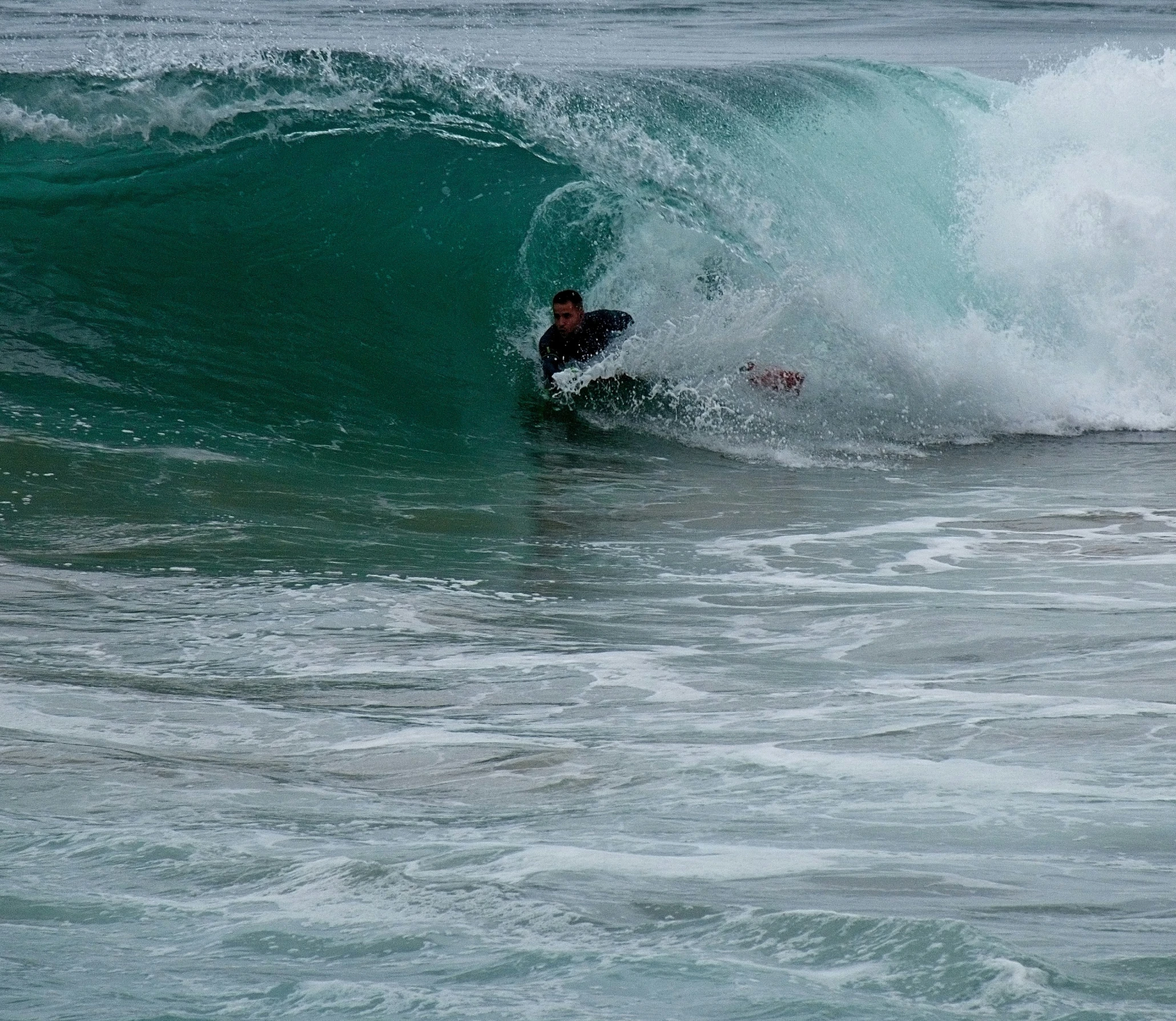 a surfer surfing on the back of a big wave