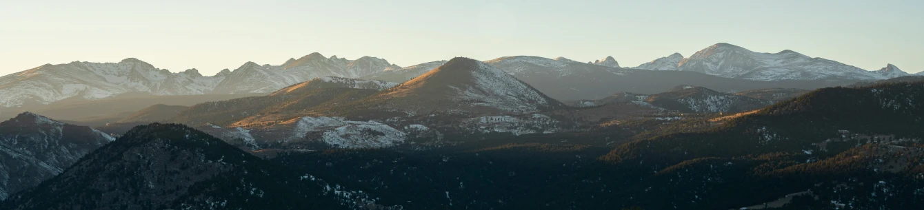 a mountain range covered in snow and the top half is lit up