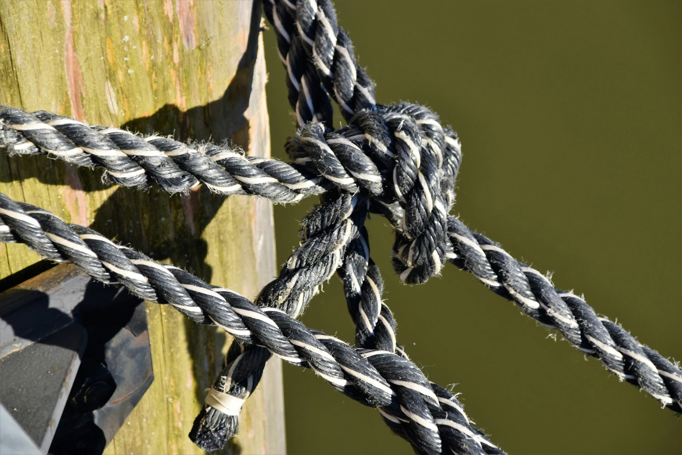 an old boat rope is connected to a wooden dock