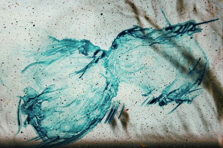 some paint is splattered on a sheet that sits on top of a bed