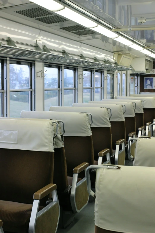 the empty seats are lined up on a passenger train